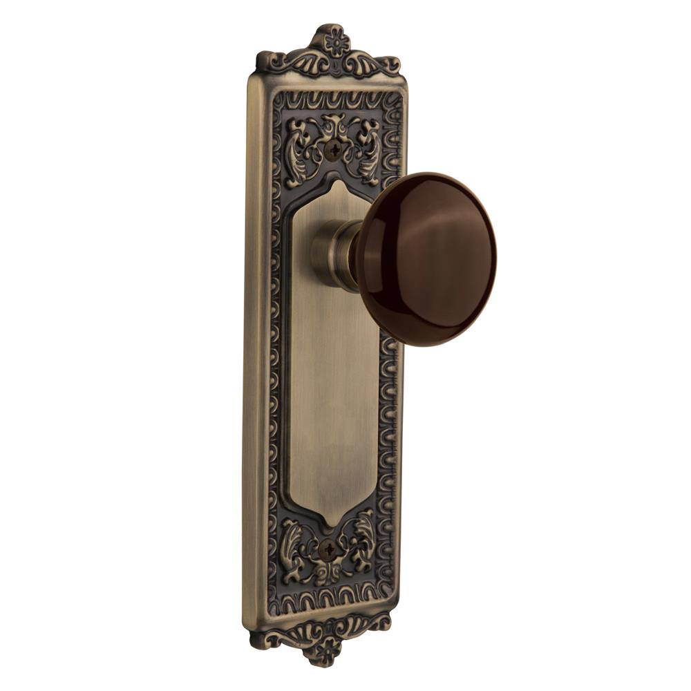 Nostalgic Warehouse EADBRN Passage Knob Egg and Dart Plate with Brown Porcelain Knob without Keyhole in Antique Brass